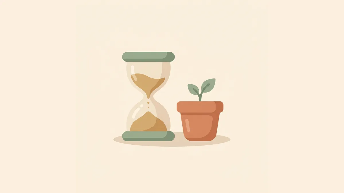 An hourglass with flowing sand beside a small sprout in a pot